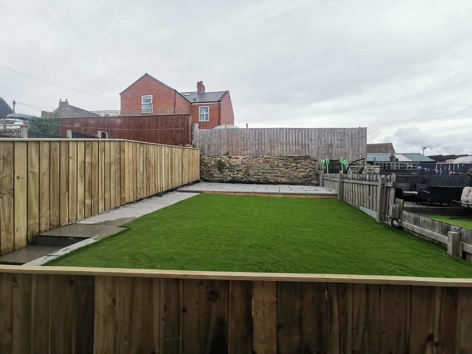 Completed garden makeover with lawn, patio and timber fencing